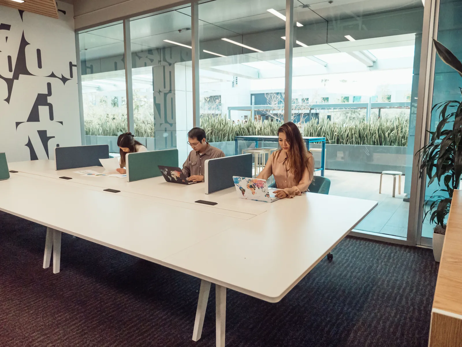People working at shared desks in a coworking space in Bali, Indonesia