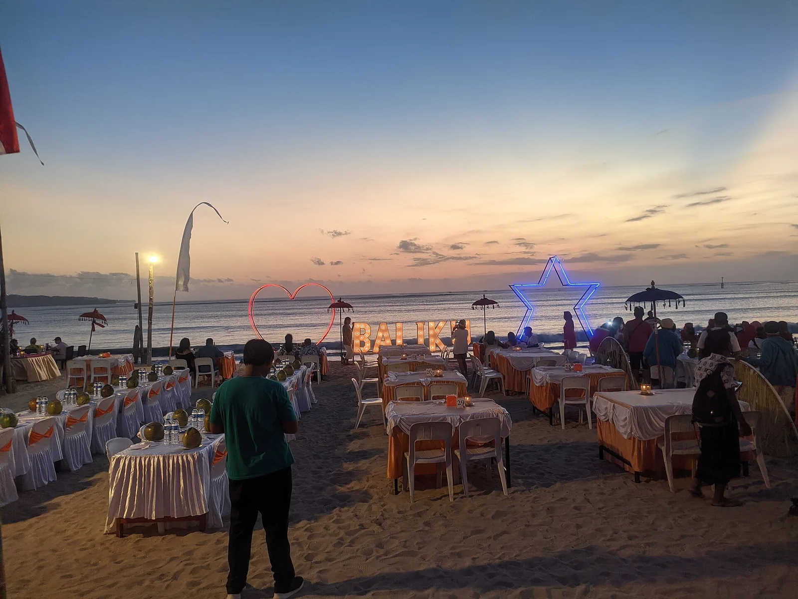 Tables set out on the sand at a seafood restaurant in Jimbaran, Bali, Indonesia