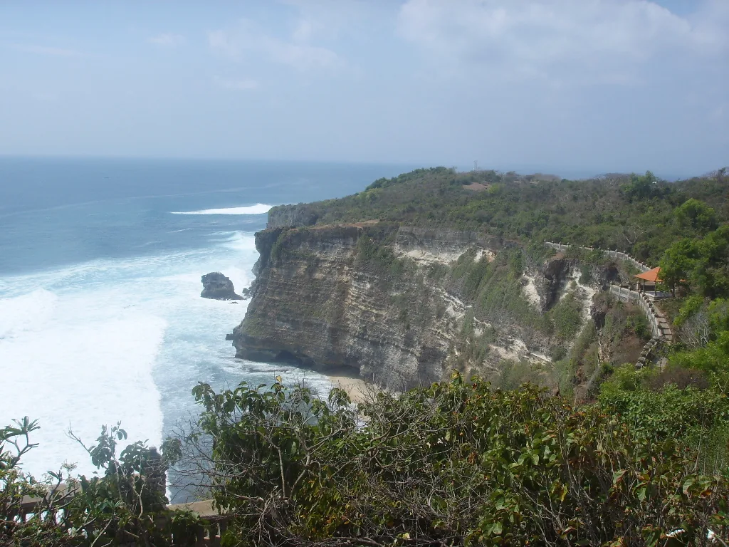 A high cliff above the surf at the end of the beach