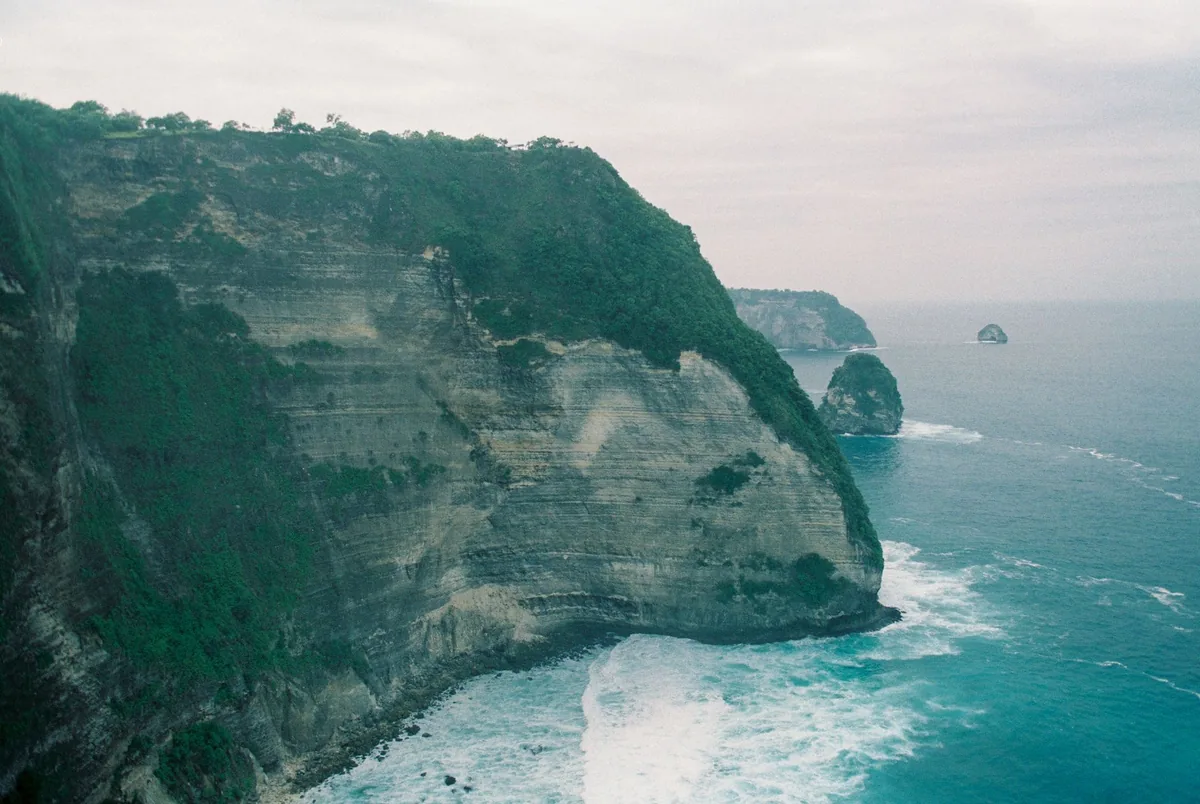 A high green cliff above the sea from the air