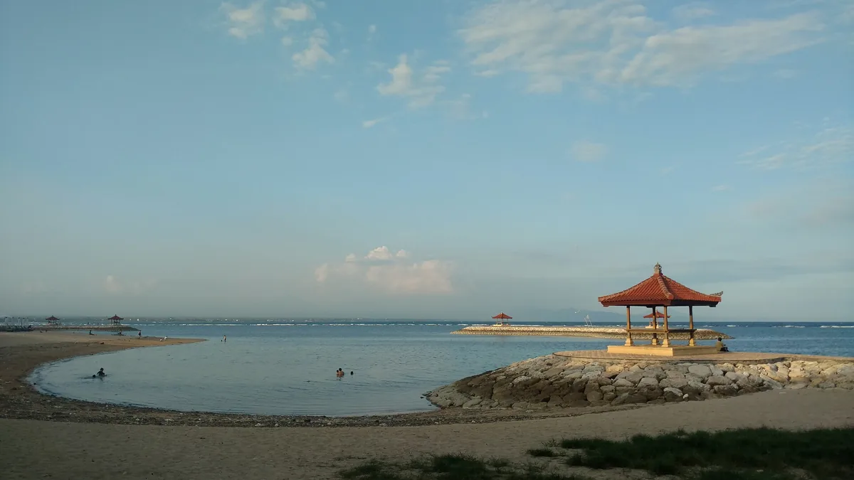 Shallow water and a covered pavilion on the beach