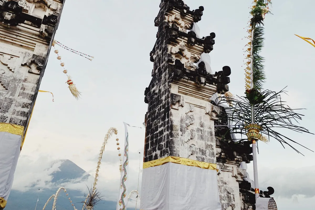Balinese temple gates with a volcano behind