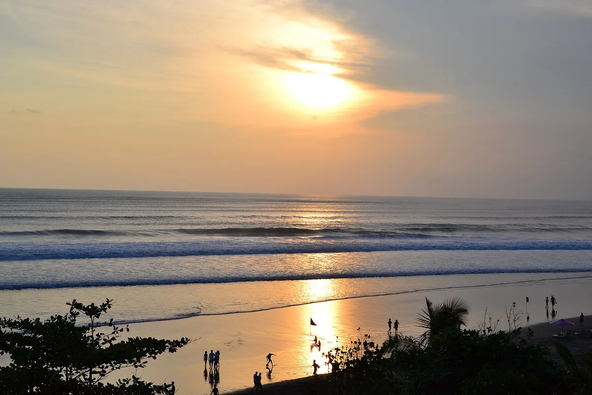 An orange sunset over the sea from the beach