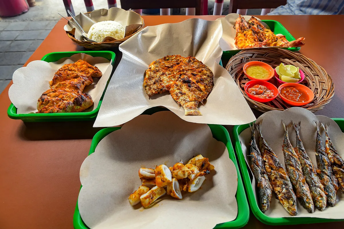 Grilled fish and seafood served on trays
