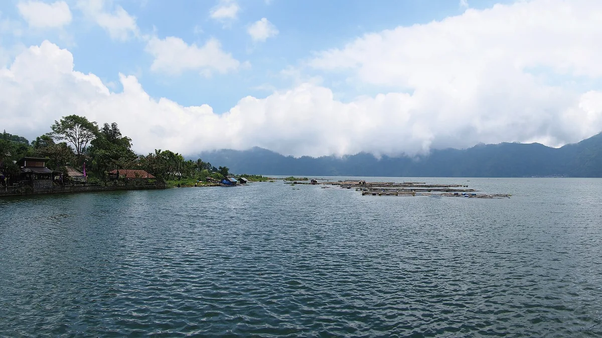 A wide lake between mountain slopes