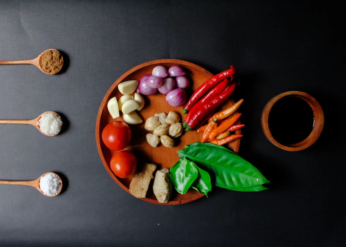 Balinese spices in a wooden bowl on a dark surface