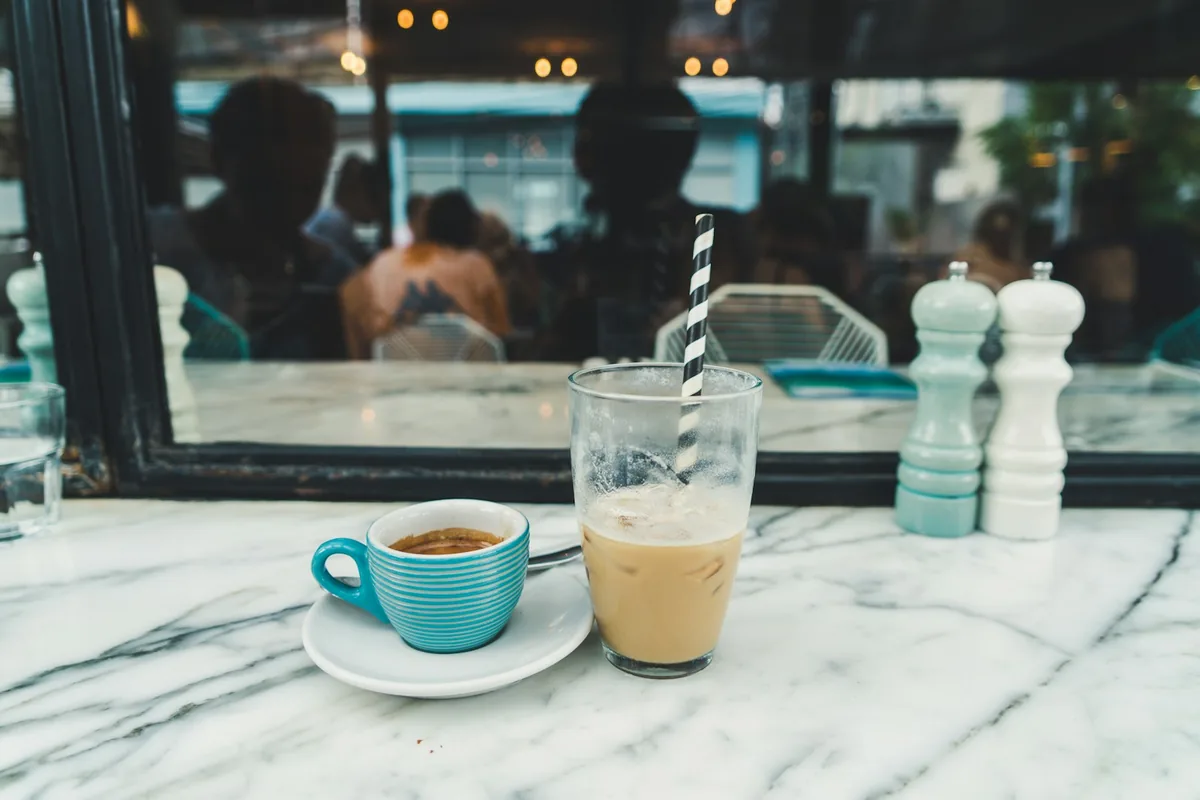 Two coffees on a marble cafe table