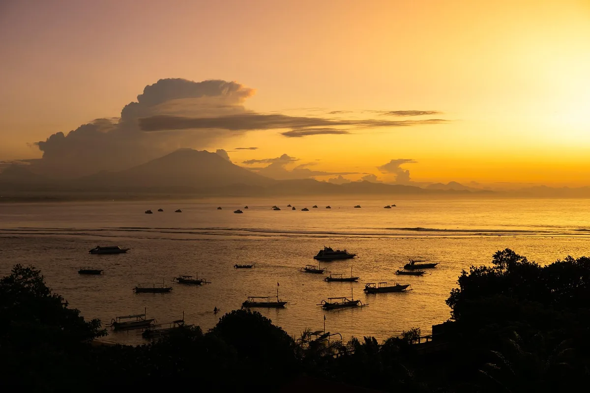 Sunrise over the sea with traditional boats