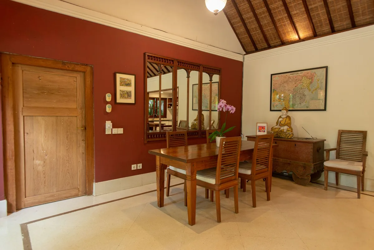 A Balinese dining room with dark wooden furniture
