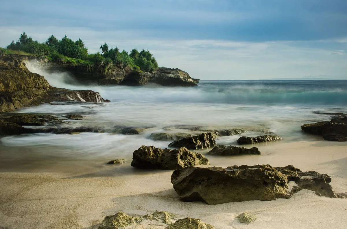 A rocky shore with waves breaking on stone