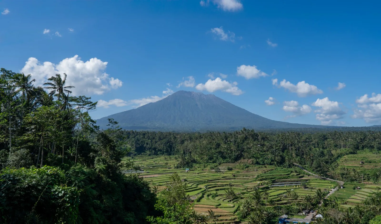 Rice terraces below a volcano in the Sidemen valley, Bali
